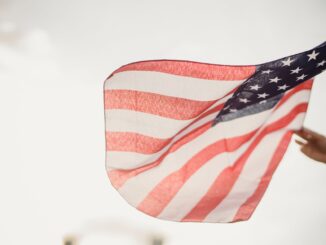 person holding an american flag